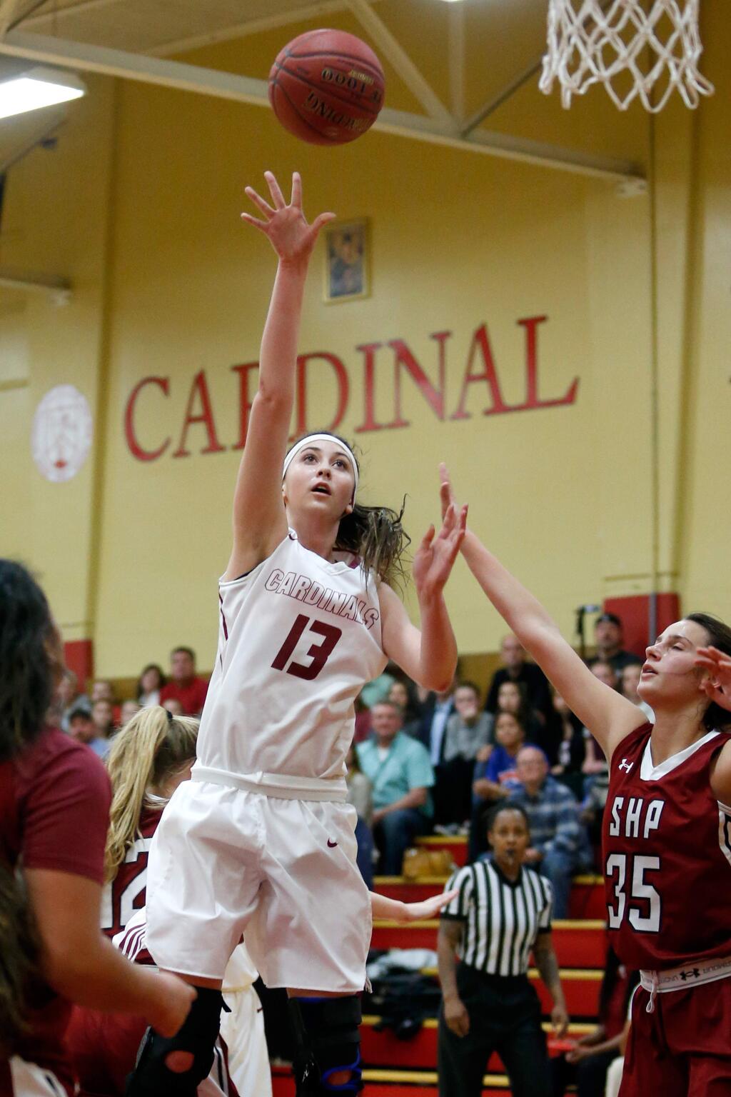 Cardinal Newman's Hailey Vice-Neat (13) gets open in the paint to score while defended by Sacred Heart's Zoe Zaharias (35), during the first half of the CIF NorCal Division 4 girls varsity basketball semifinal game between Sacred Heart Prep and Cardinal Newman high schools in Santa Rosa, California on Tuesday, March 15, 2016. (Alvin Jornada / The Press Democrat)