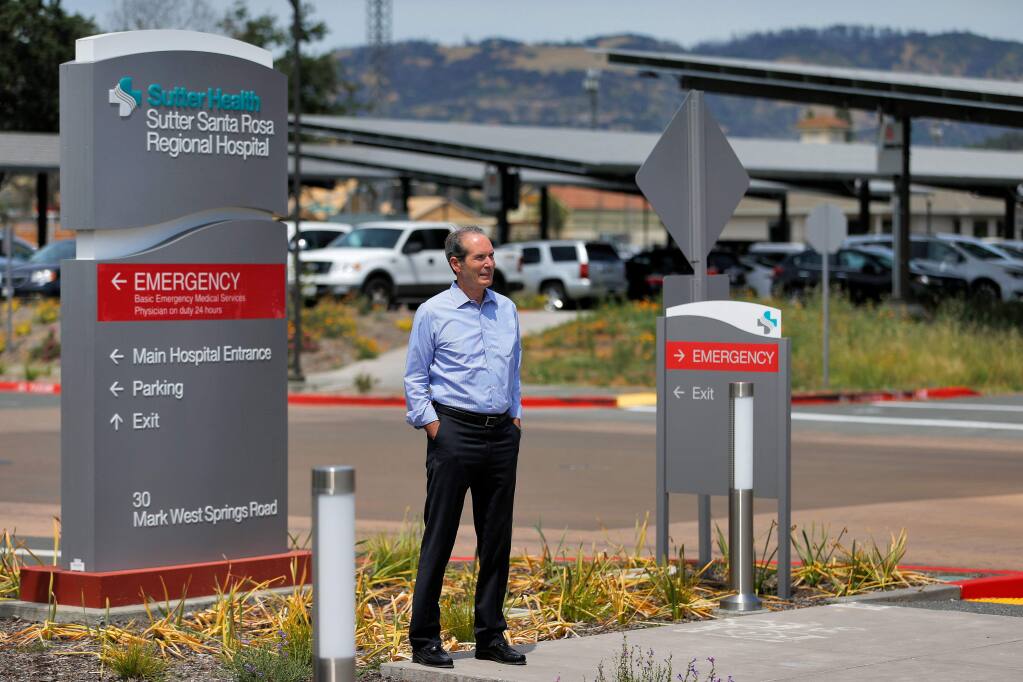 Sutter Santa Rosa Regional Hospital CEO Mike Purvis stands in front of some of the solar panel arrays placed in Sutter hospital's parking lots in Santa Rosa, California, on Thursday, June 13, 2019. (Alvin Jornada / The Press Democrat)