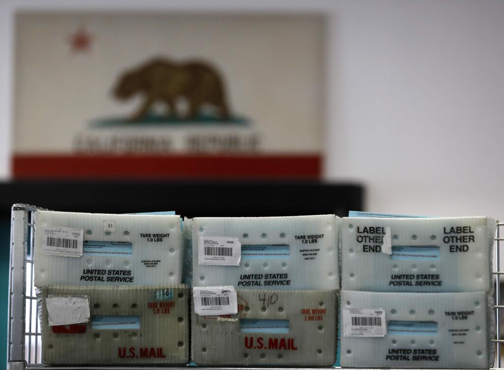 Boxes of vote-by-mail ballots sit sorted, but yet to be counted at the Sonoma County Registrar of Voters Office on Wednesday, Nov. 7, 2018, in Santa Rosa, California. (BETH SCHLANKER/ PD)