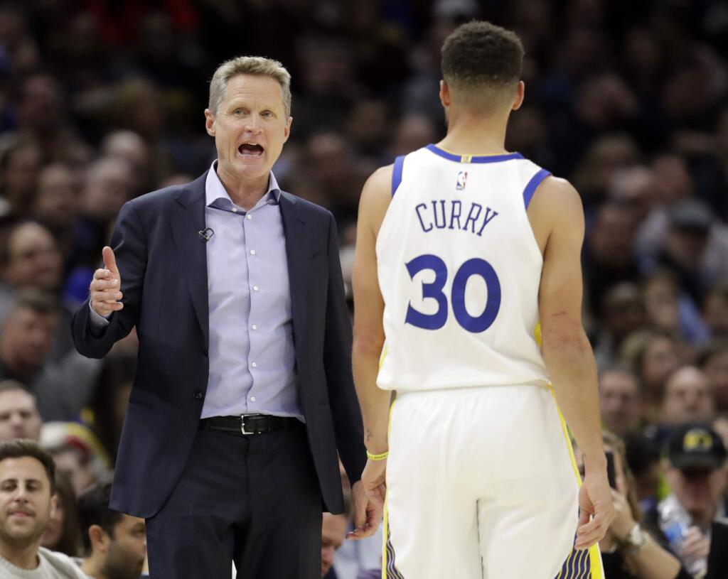 Golden State Warriors head coach Steve Kerr, left, talks with Stephen Curry in the second half of an NBA basketball game against the Cleveland Cavaliers, Monday, Jan. 15, 2018, in Cleveland. (AP Photo/Tony Dejak)