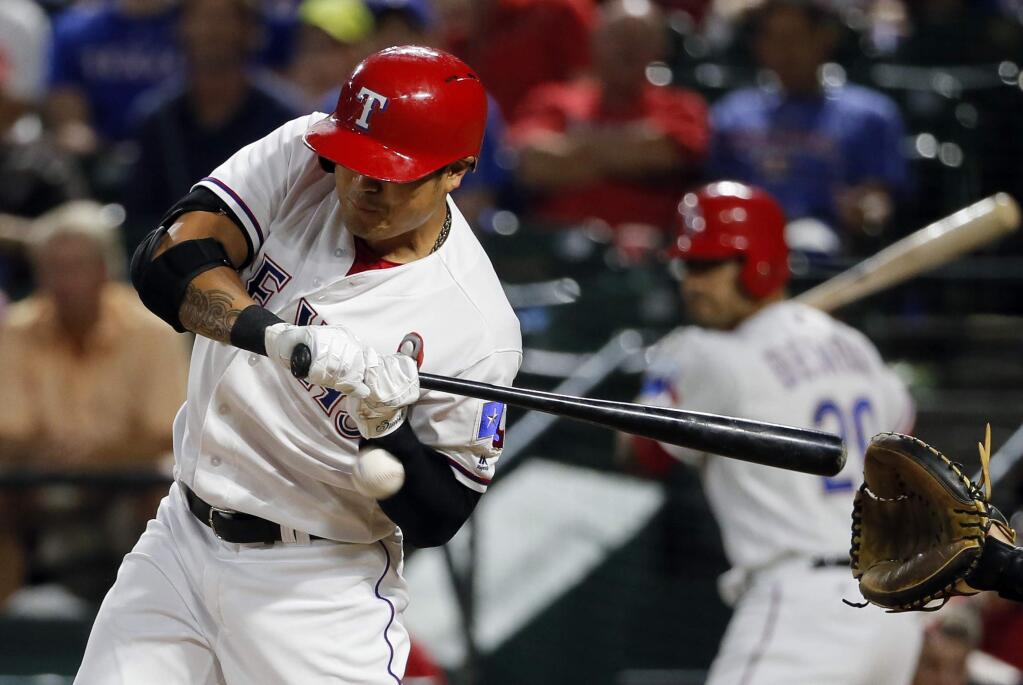 Texas Rangers' Shin-Soo Choo, of South Korea, is hit in the left wrist by a pitch from Oakland Athletics starting pitcher Ross Detwiler in the fifth inning of a baseball game, Monday, Aug. 15, 2016, in Arlington, Texas. (AP Photo/Tony Gutierrez)