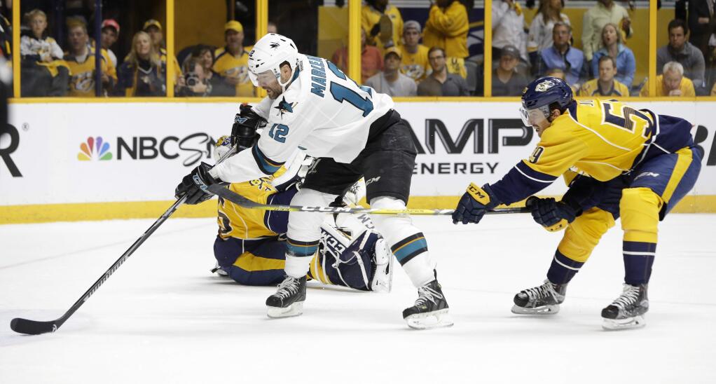 San Jose Sharks left wing Patrick Marleau (12) scores a goal against Nashville Predators goalie Pekka Rinne, of Finland, and defenseman Roman Josi (59), of Switzerland, during the first period in Game 3 of an NHL hockey Stanley Cup Western Conference semifinal playoff series Tuesday, May 3, 2016, in Nashville, Tenn. (AP Photo/Mark Humphrey)