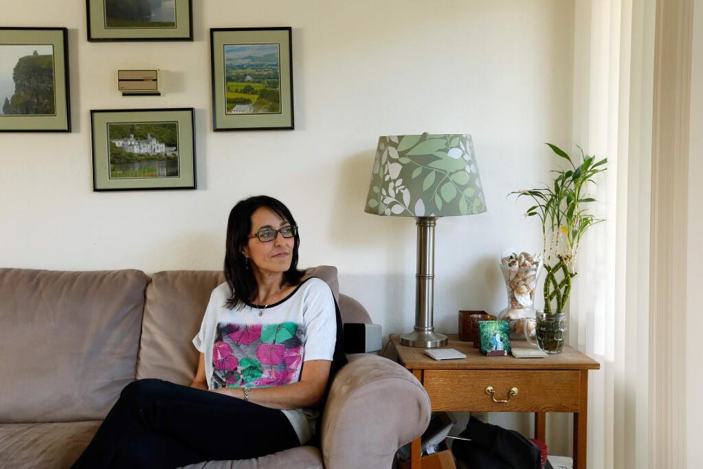 Andrea Cashman sits in her living room at the Montevista Apartments in San Rafael, California, on Thursday, May 3, 2018. (Alvin Jornada / The Press Democrat)