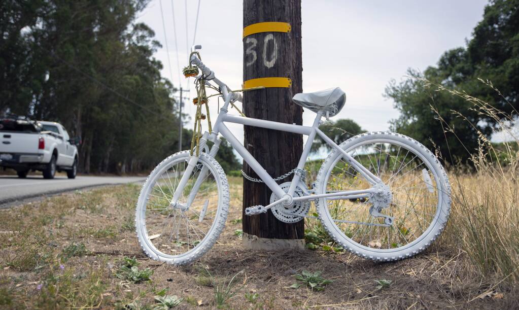 A bicycle painted gray, chained to a power pole on Highway 12, where a bicyclist was the fatal victim of a hit and run. Among bicyclists, it is known as a "ghost bike," and is placed at the scene of every fatal bicycle accident as a tribute to and remembrance of the rider.(Photo by Robbi Pengelly/Index-Tribune)