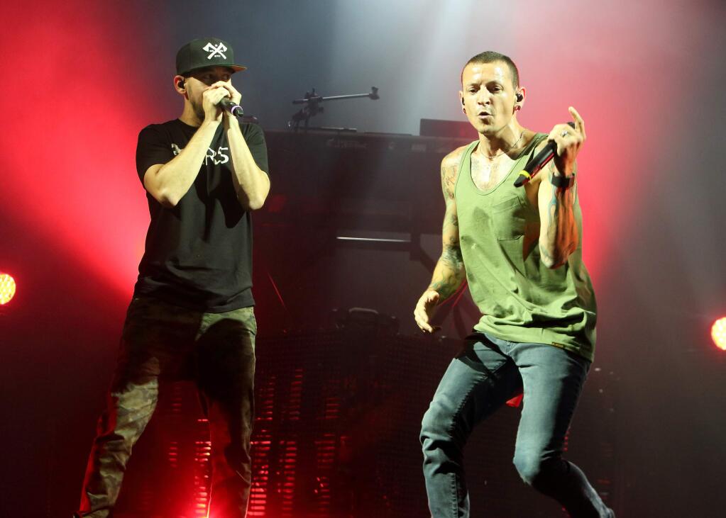 FILE - In this Aug. 15, 2014 file photo, Mike Shinoda, left, and Chester Bennington of the band Linkin Park perform in concert during their 'Carnivores Tour 2014' at the Susquehanna Bank Center in Camden, N.J. Linkin Park is canceling the rest of its U.S. tour after its lead singer injured his leg. Bennington says in a statement Tuesday, Jan. 20, 2015, that he needs immediate medical attention and that it is impossible for him to perform. (Photo by Owen Sweeney/Invision/AP, File)