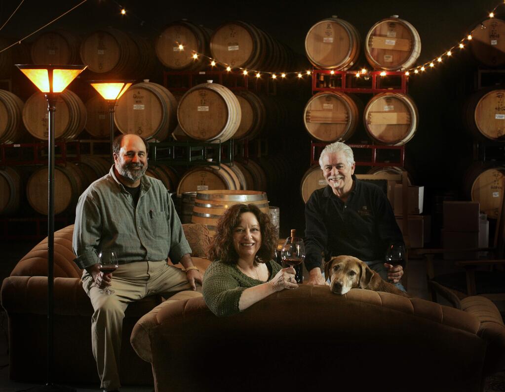 Ben Papapietro, left, Renae Perry, her husband, Bruce, and dog Ruby hang out in their 'living room,' which these owners of Papapietro Perry Winery use as a tasting area for special events. (Charlie Gesell/ The Press Democrat, 2007)