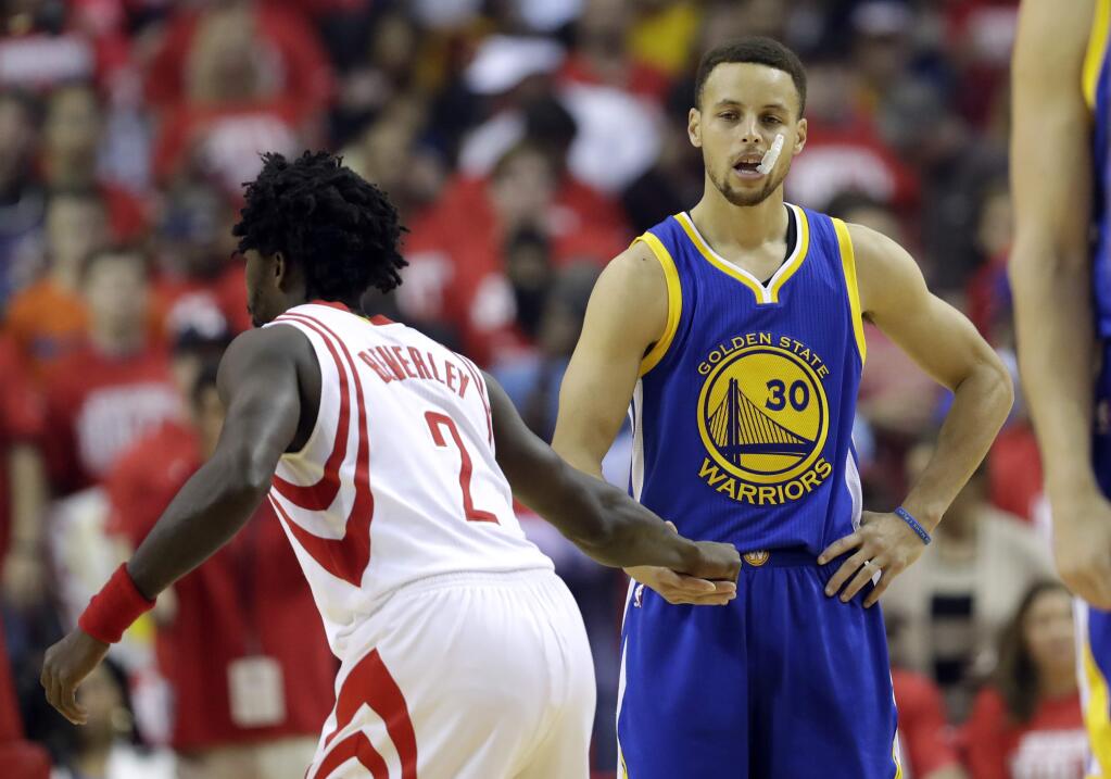 Golden State Warriors' Stephen Curry, right, shakes hands with Houston Rockets' Patrick Beverley just prior to the tip off for Game 4 of a first-round NBA basketball playoff series, Sunday, April 24, 2016, in Houston. (AP Photo/David J. Phillip)