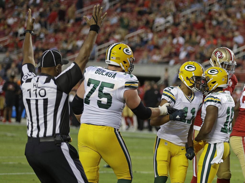 Green Bay Packers wide receiver Randall Cobb, right, is greeted by teammates Trevor Davis (11) and Bryan Bulaga (75) after scoring a touchdown during the first half of an NFL preseason football game against the San Francisco 49ers on Friday, Aug. 26, 2016, in Santa Clara, Calif. (AP Photo/Ben Margot)