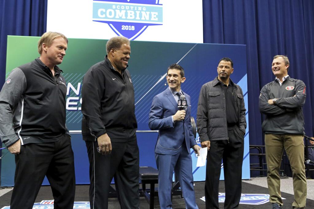 From left, Oakland Raiders head coach Jon Gruden, GM Reggie McKenzie, NFL Network host Andrew Siciliano, Hall of Famer Rod Woodson and San Francisco 49ers GM John Lynch are seen at the official coin flip to determine the 9th and 10th picks for the 2018 NFL fraft on Friday, March 2, 2018, in Indianapolis. (AP Photo/Gregory Payan)