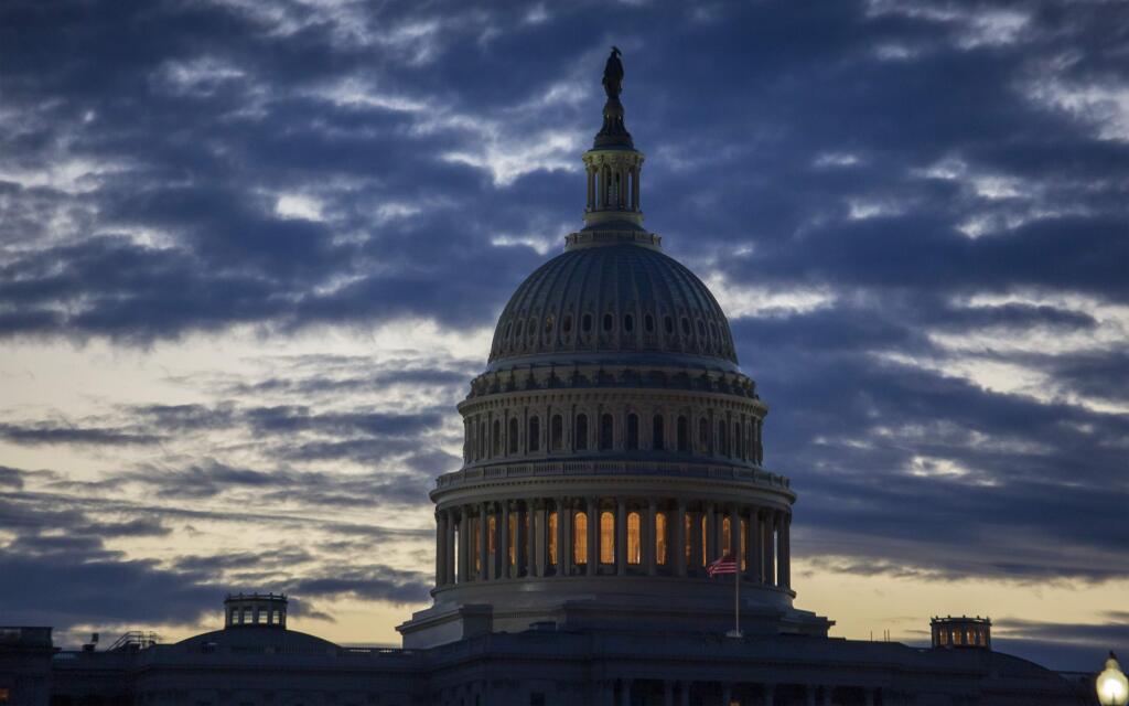 FILE- In this Jan. 8, 2019, file photo dawn arrives at the Capitol in Washington. On Thursday, Jan. 17, the Labor Department reports on the number of people who sought unemployment benefits last week, a figure likely to be inflated by applications from federal employees who aren't working because of the partial government shutdown. (AP Photo/J. Scott Applewhite, File)