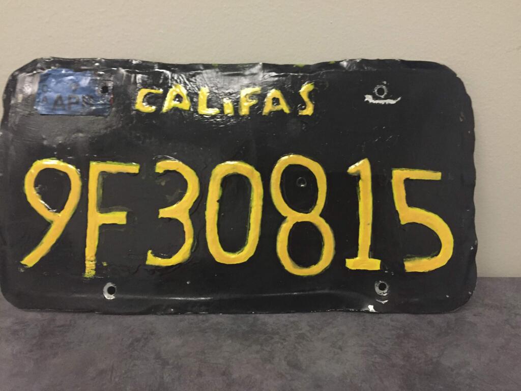 This undated photo provided by the Ventura County Sheriff's Department shows a phony license plate. A big-rig truck driver has been arrested after authorities spotted this phony license plate on his rig. Ventura County Sheriff's Department says the 1960s-style yellow-on-black plate had wobbly letters and numbers. Also, instead of 'CALIFORNIA,' it reads 'CALIFAS.' The department said Monday, June 10, 2019, that a motorcycle officer spotted the plate and pulled the driver over in the city of Moorpark, northwest of Los Angeles. (Ventura County Sheriff's Department via AP)