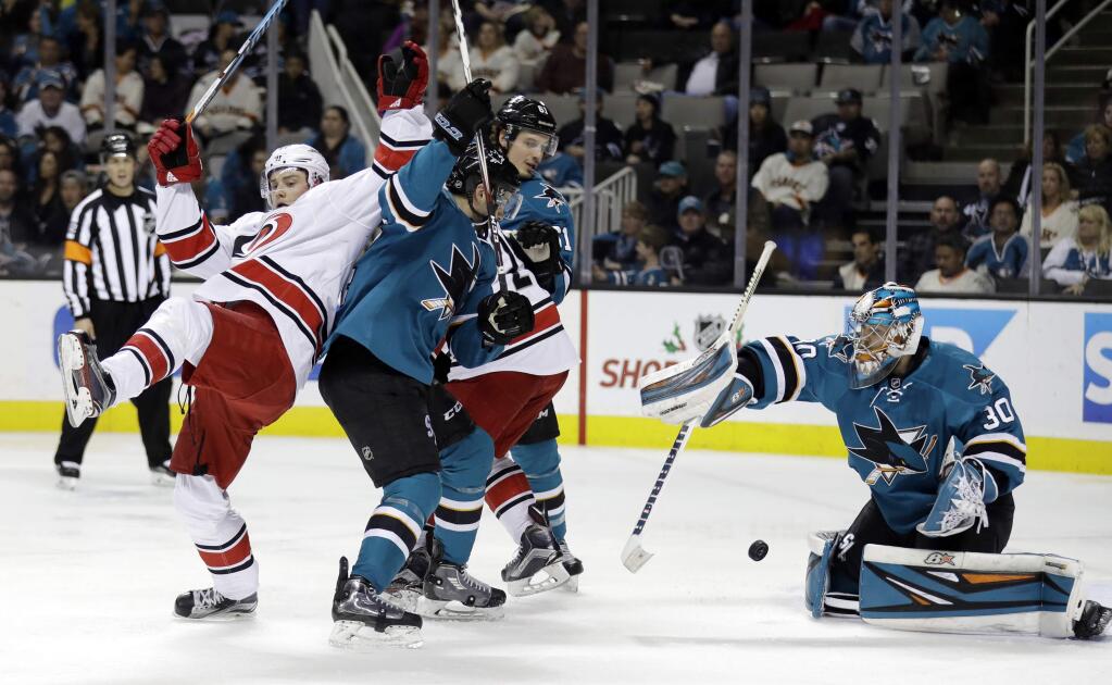 San Jose Sharks goalie Aaron Dell, right, stops a shot by the Carolina Hurricanes during the second period Saturday, Dec. 10, 2016, in San Jose. (AP Photo/Marcio Jose Sanchez)