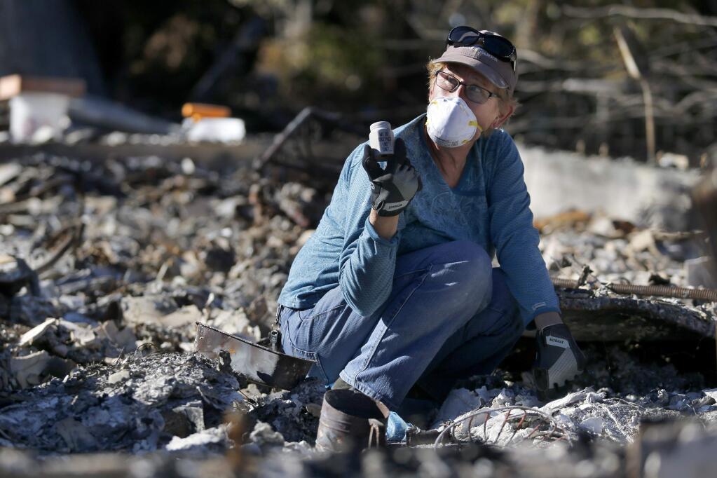 Jane Witkowski shows her husband Mike a salt shaker she found while looking through the rubble of their O'Donnell Lane home where they have lived since 1975. Photo taken on Sunday, October 22, 2017 in Glen Ellen, California . (BETH SCHLANKER/The Press Democrat)