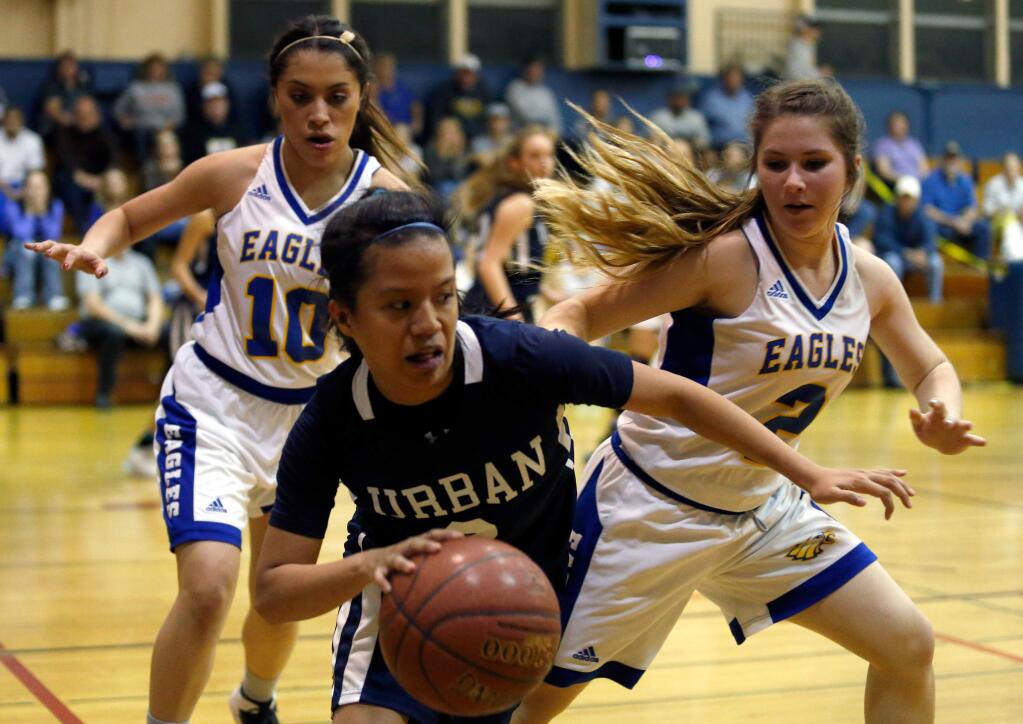 Urban's CJ Catina, center, is pressured by Cloverdale's Alejandra Perez, left, and Jaedyn Jenkins, right, in an NCS semifinal game on Wednesday, March 2, 2016. (Alvin Jornada / The Press Democrat)