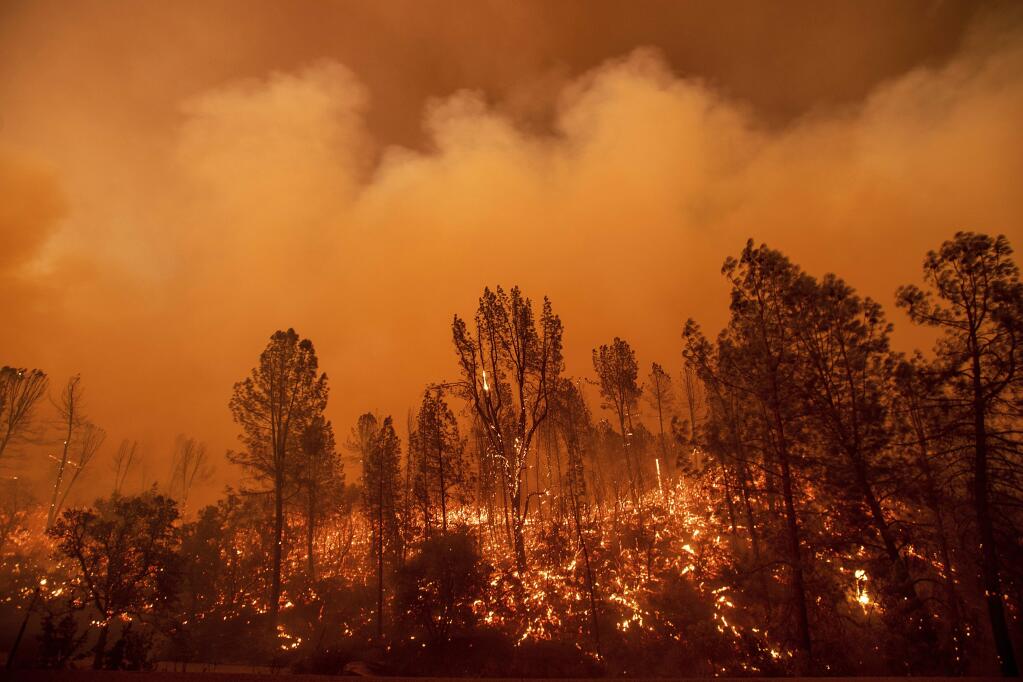The Carr Fire burns along Highway 299 in Redding on July 26. (NOAH BERGER / Associated Press)