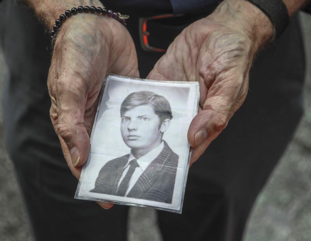In this Wednesday, Aug. 7, 2019 photo, Brian Toale shows a photo of himself at 16 years old in New York. Thousands of people who say they were molested as children in New York state will head to court this week to file lawsuits against their alleged abusers and the institutions where they worked. Toale, 66, who says he was molested by an employee at a Catholic high school he attended on Long Island, was one of the leaders in the fight to pass the Child Victims Act. (AP Photo/Bebeto Matthews)