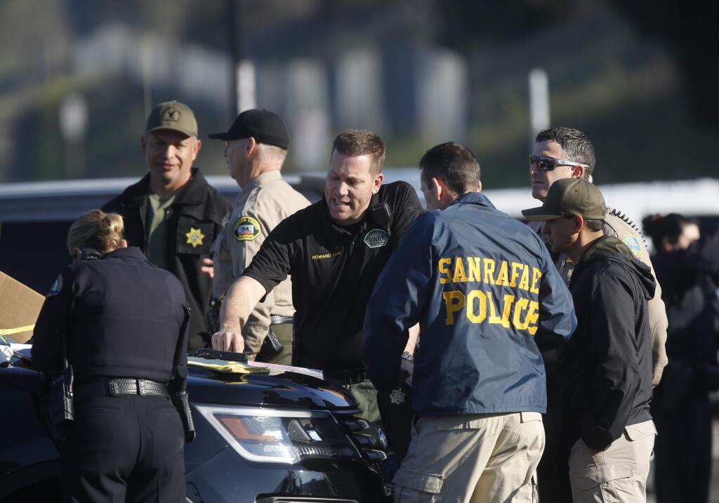 Multiple law enforcement agencies work together at a command center set up at the SMART Novato San Marin station on Monday, March 12, 2018 in Novato, California . (BETH SCHLANKER/The Press Democrat)