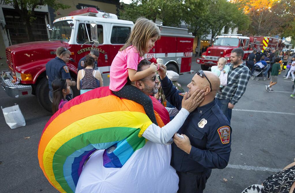 Tony Bugica and his daughter Prima, 4, thank their Geyserville fire captain Joe Stewart during the Welcome Home Healdsburg event to thank first responders for saving the city from Kincade fire. (photo by John Burgess/The Press Democrat)