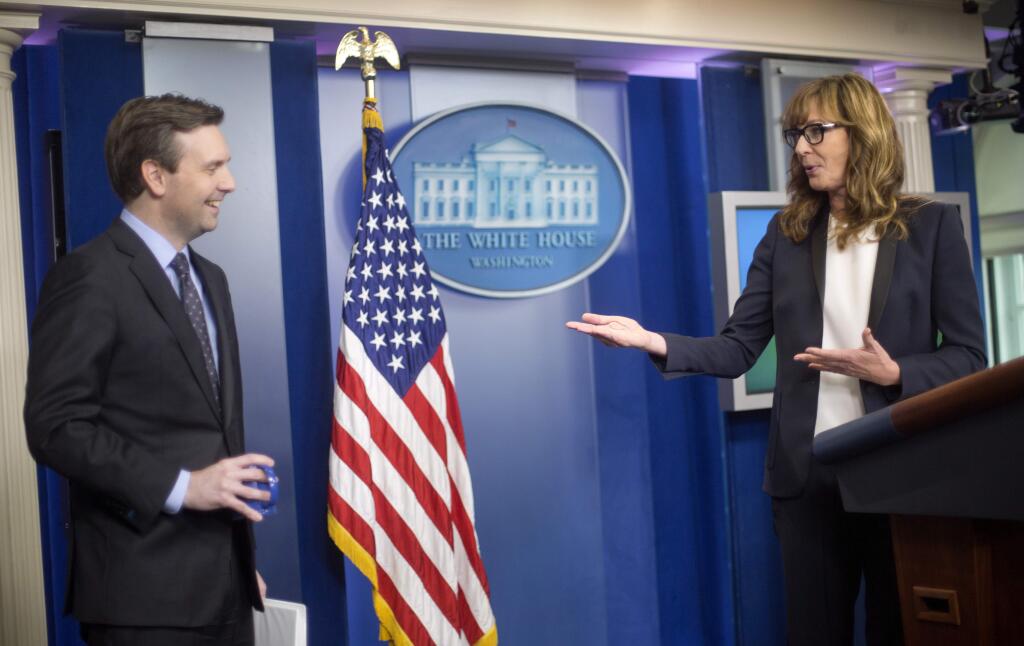 White House Press Secretary Jay Carney reacts to seeing actress Allison Janney at the podium at the White House Press Briefing Room on Friday. Janney played presidential press secretary C.J. Cregg on the television drama 'The West Wing.' (PABLO MARTINEZ MONSIVAIS / Associated Press)