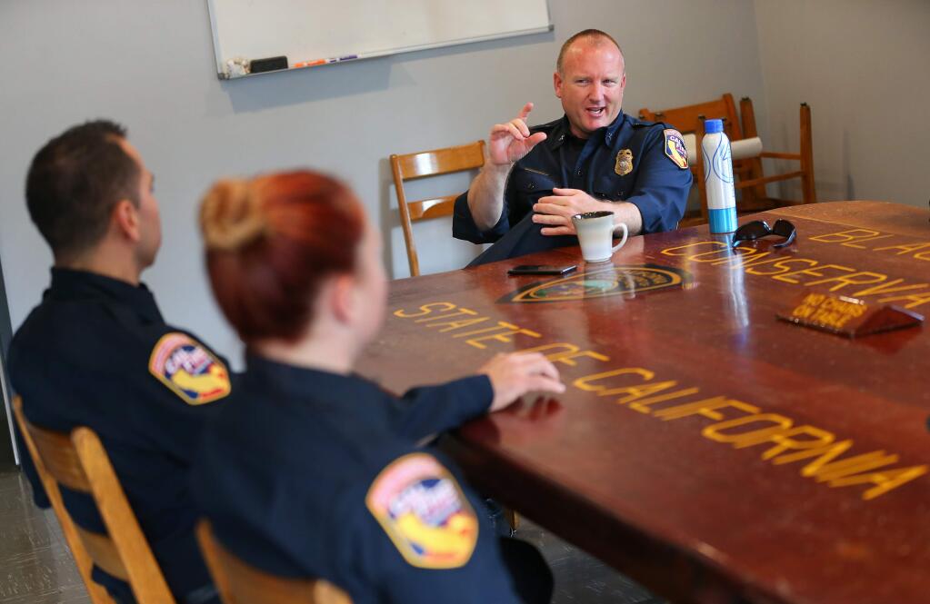 CAL FIRE Battalion Chief Marshall Turbeville, right, meets with fire personnel at the CAL FIRE Hilton Station in Guerneville on Friday, November 15, 2019. (Christopher Chung/ The Press Democrat)