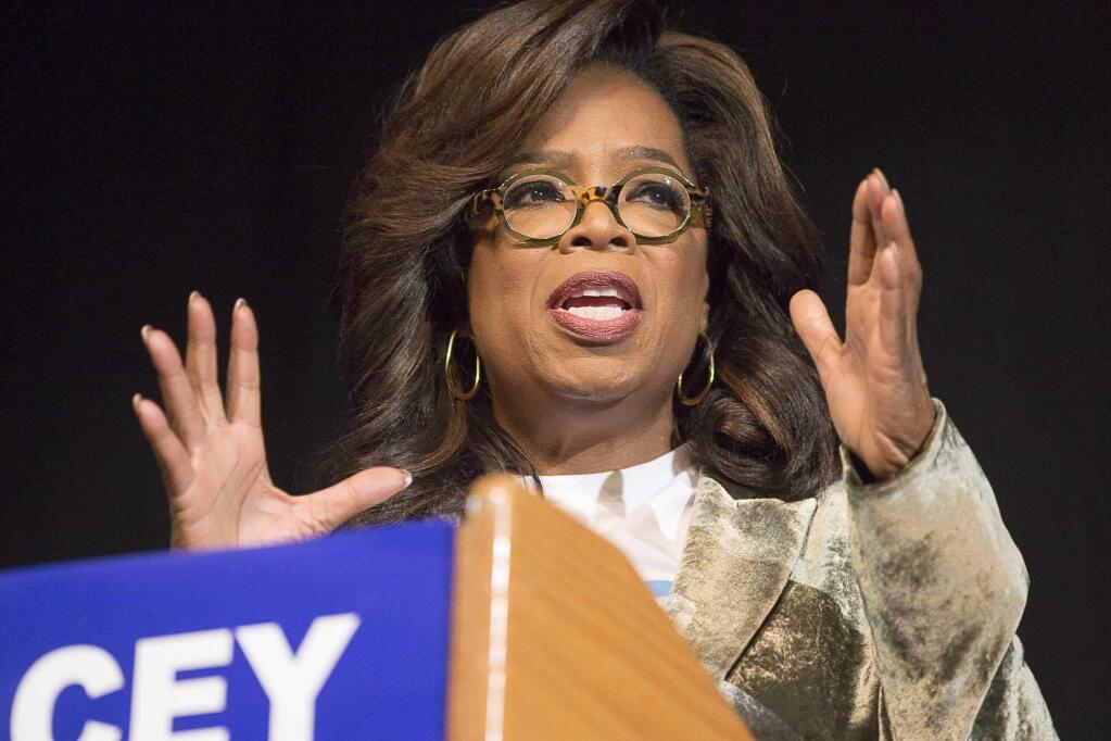 Oprah Winfrey speaks to a crowd during a town hall conversation for gubernatorial candidate Stacey Abrams at the Cobb Civic Center's Jennie T. Anderson Theatre in Marietta, Ga., Thursday, Nov. 1, 2018. Winfrey visited Georgia on Thursday to canvass neighborhoods in Metro Atlanta and show her support for gubernatorial candidate Stacey Abrams. (Alyssa Pointer /Atlanta Journal-Constitution via AP)