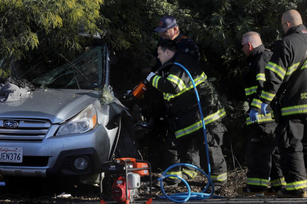Schell-Vista fire fighters use hydraulic rescue tools to cut into a Subaru Outback to free the body of the deceased 35-year-old male driver after being involved in a collision with an alleged drunk driver of a BMW at 8th Street and East Napa Rd. in Sonoma on Sunday, January 26, 2020. (BETH SCHLANKER/ The Press Democrat)