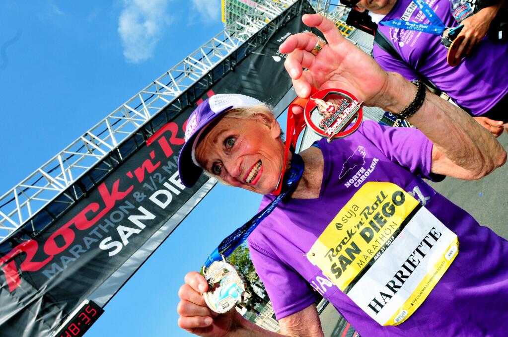 In this photo provided by Competitor Group, Harriette Thompson poses after finishing the Suja Rock n Roll Marathon in San Diego on Sunday, May 31, 2015. Thompson, of Charlotte, N.C., at 92 years and 65 day old on the day of the race, is a two-time cancer survivor who dealt with the loss of her husband and a staph infection in her legs while training for this years race. (Paul Nestor/Competitor Group via AP)