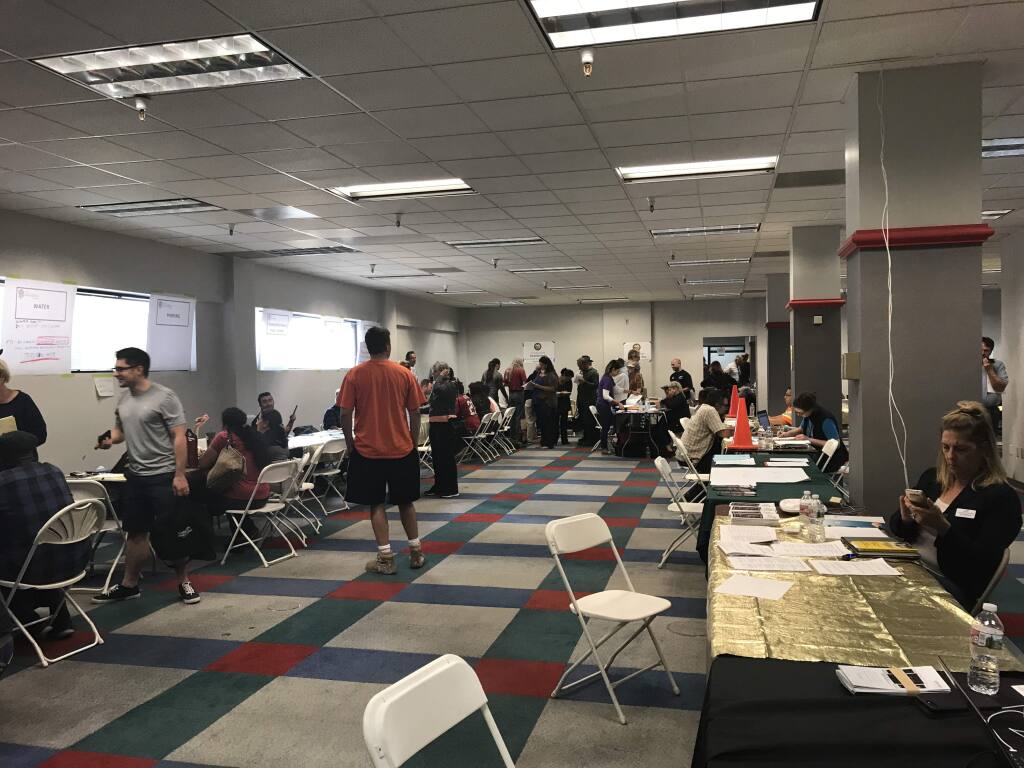 Some of the thousands of fire victims sign in at the reception area at the Santa Rosa local assistance center on opening day, Oct. 14, 2017.