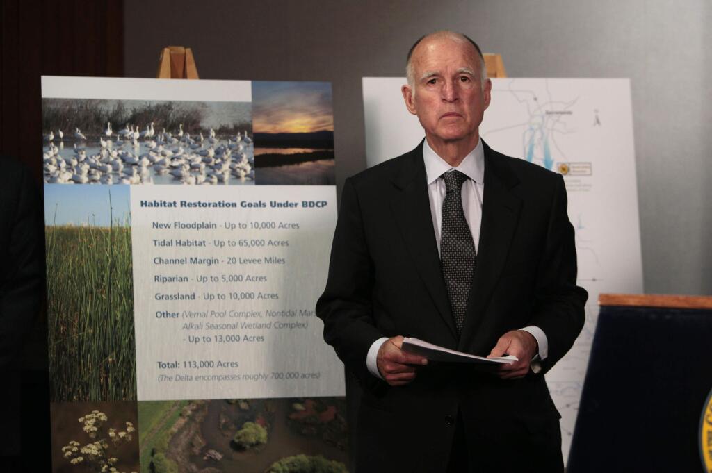 FILE - In this July 25, 2012, file photo, California Gov. Jerry Brown waits for the start of a news conference in Sacramento, Calif., to announce plans to build a giant twin tunnel system to move water from the Sacramento-San Joaquin River Delta to farmland and cities. A new federal audit says the federal government improperly spent tens of millions of dollars on the California water project. An audit by the inspector general's office of the U.S. Interior Department says federal officials contributed the taxpayer money to Gov. Jerry Brown's plans to build two giant water tunnels. (AP Photo/Rich Pedroncelli, File)