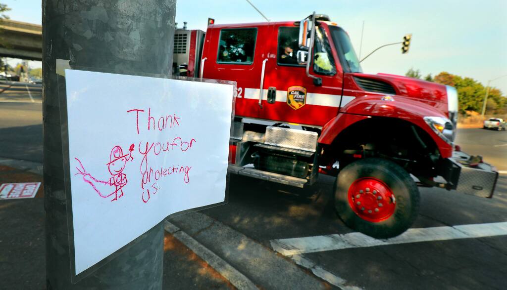 A sign created by a child greet fire trucks as they return for a rest at the Sonoma County Fairgrounds on October 12, 2017. (photo by John Burgess/The Press Democrat)