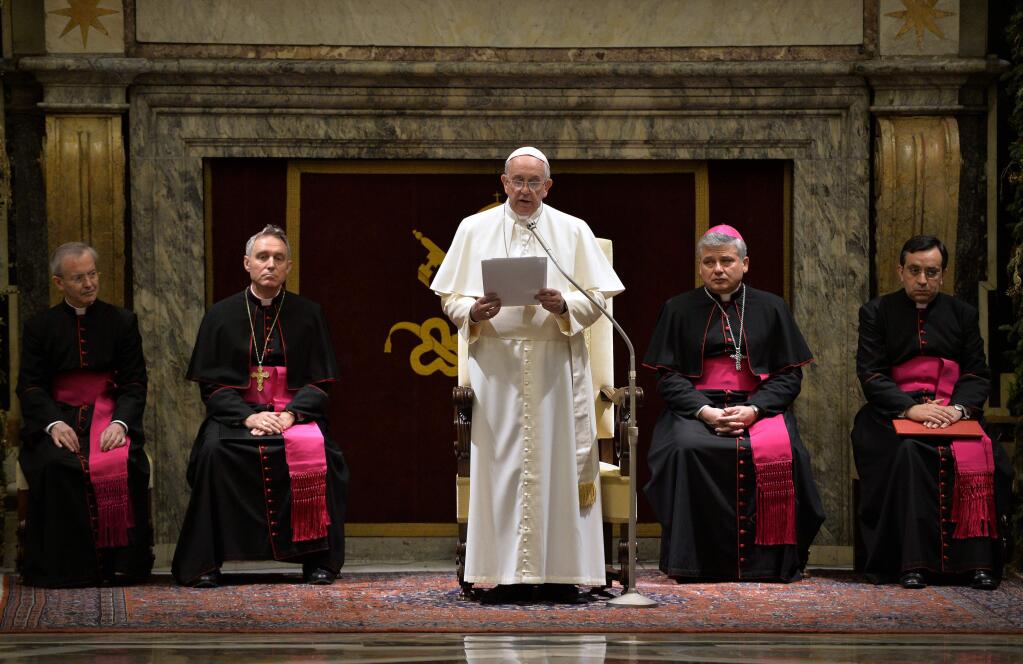 Pope Francis delivers his message during a meeting with Cardinals and Bishops of the Vatican Curia on the occasion of the exchange of Christmas greetings in the Clementine hall at Vatican, Monday, Dec. 22, 2014. (AP Photo/Andreas Solaro, Pool)