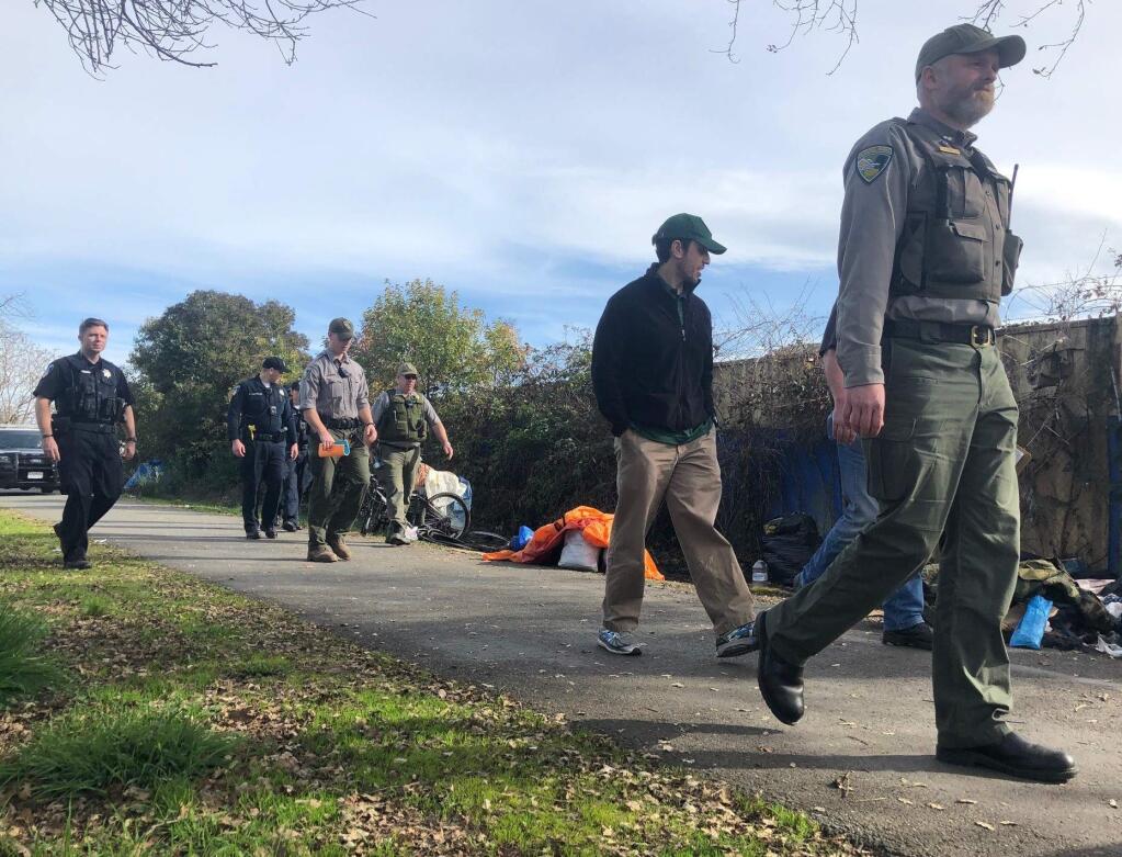 Sonoma County park rangers give homeless people notice to move from the Joe Rodota Trail in west Santa Rosa on Wednesday, Jan. 29, 2020. (BETH SCHLANKER/ PD)