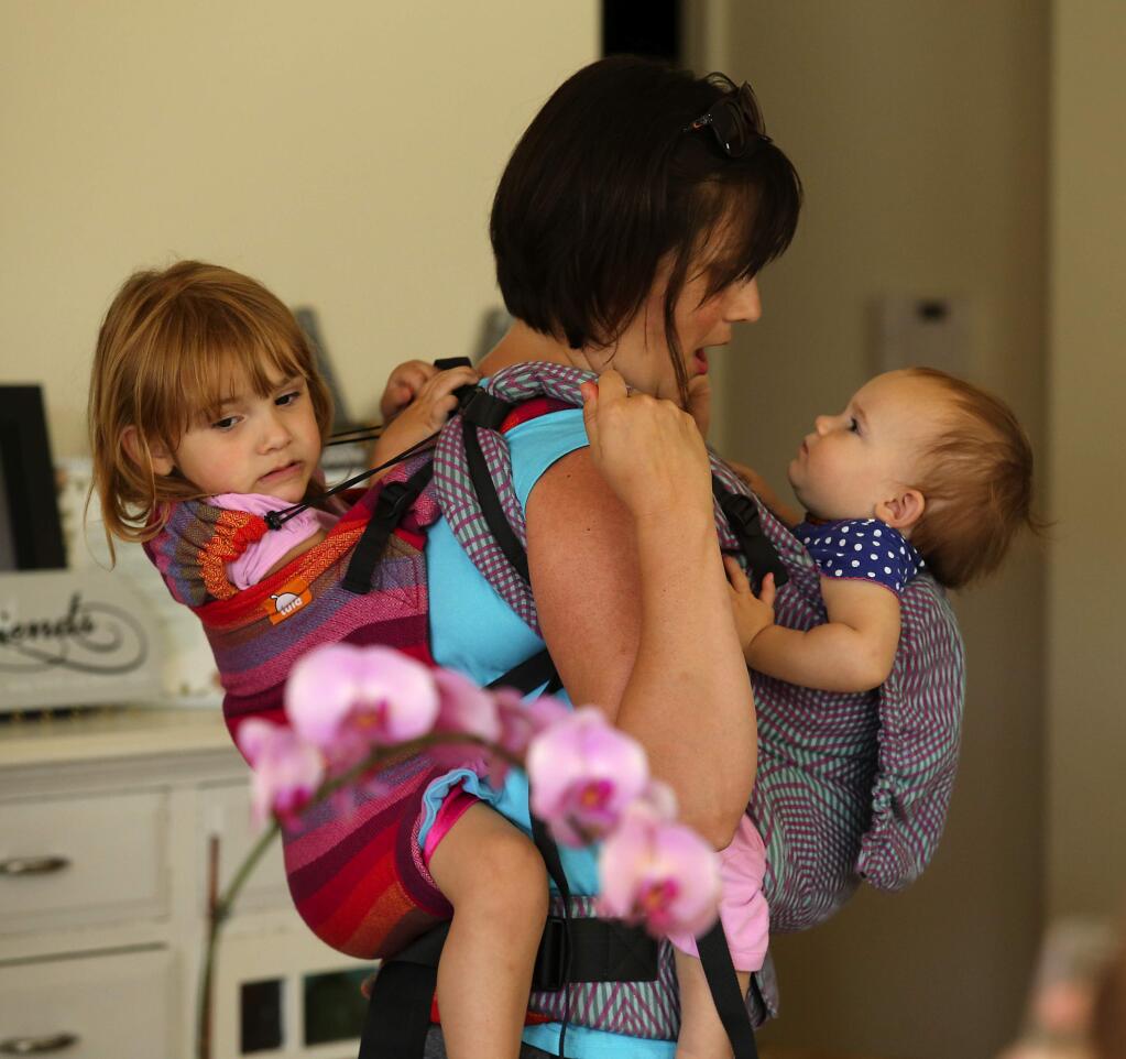 Photos by JOHN BURGESS / The Press DemocratTwice as nice: Rachel Snyder carries a double load - Freya, 1, on the front, and Clara, 2, on the back - during a lunch with members of the Sonoma County Tula Mamas in Petaluma. Groups of babywearers have formed all over the United States, partially because of the growth of attachment parenting.