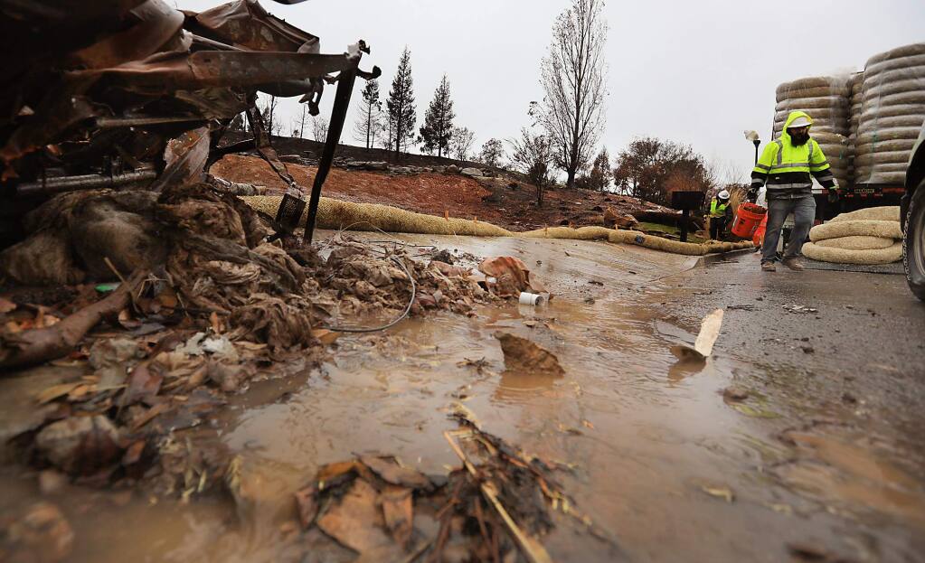 A small debris flow pushes from a cleared lot on Heathfield Place, Monday Jan. 8, 2018 in Fountaingrove, due to rainfall. (Kent Porter / The Press Democrat) 2018