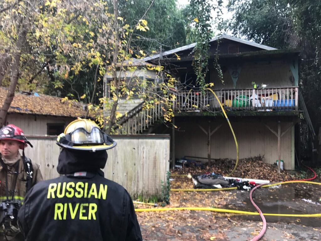 Firefighters at the scene of a house fire on Northern Avenue in Guerneville on Tuesday, Dec. 4, 2018. (BETH SCHLANKER/ PD)