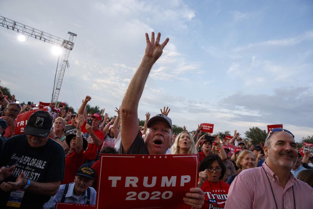 Supporters of President Donald Trump cheer as he arrives to speak at a rally at Aaron Bessant Amphitheater, Wednesday, May 8, 2019, in Panama City Beach, Fla. (AP Photo/Evan Vucci)