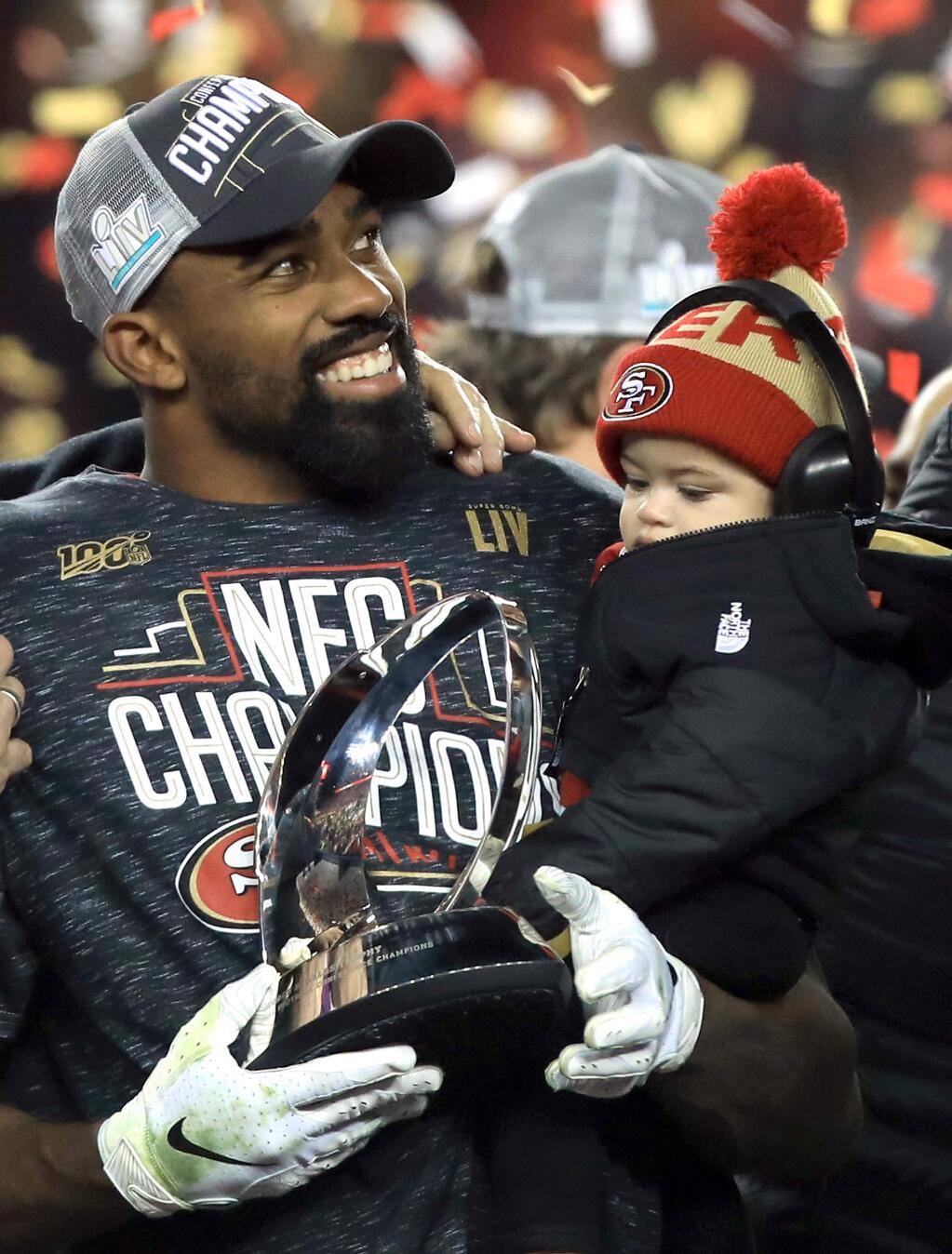 Raheem Mostert celebrates with his son Gunner with the George Halas trophy after San Francisco's 37-20 win over Green Bay in the NFC Championship game, Sunday, January 19, 2020 in Santa Clara. (Kent Porter / The Press Democrat) 2020