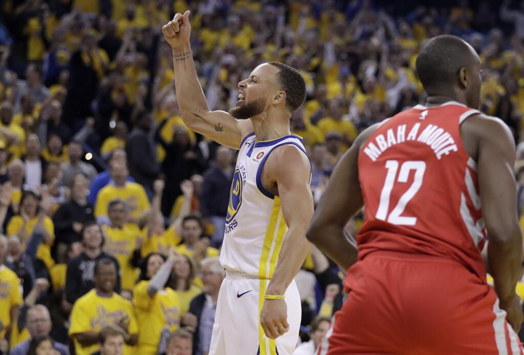 Golden State Warriors guard Stephen Curry (30) celebrates next to Houston Rockets forward Luc Mbah a Moute (12) during the second half of Game 3 of the NBA basketball Western Conference Finals in Oakland, Calif., Sunday, May 20, 2018. (AP Photo/Marcio Jose Sanchez)