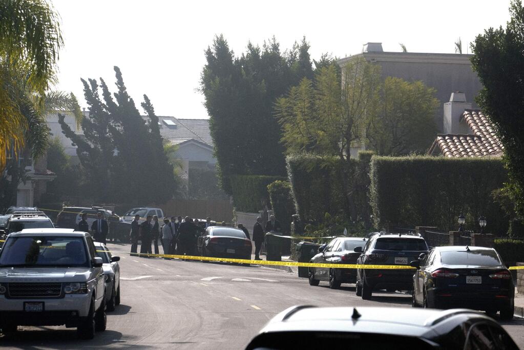 Police investigate a Hollywood Hills home where a fatal shooting occurred on Wednesday, Feb. 19, 2020, in Los Angeles. (AP Photo/Ringo H.W. Chiu)
