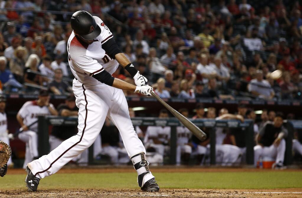 The Arizona Diamondbacks' J.D. Martinez connects for a home run against the San Francisco Giants during the ninth inning Wednesday, Sept. 27, 2017, in Phoenix. The Diamondbacks defeated the Giants 4-3. (AP Photo/Ross D. Franklin)