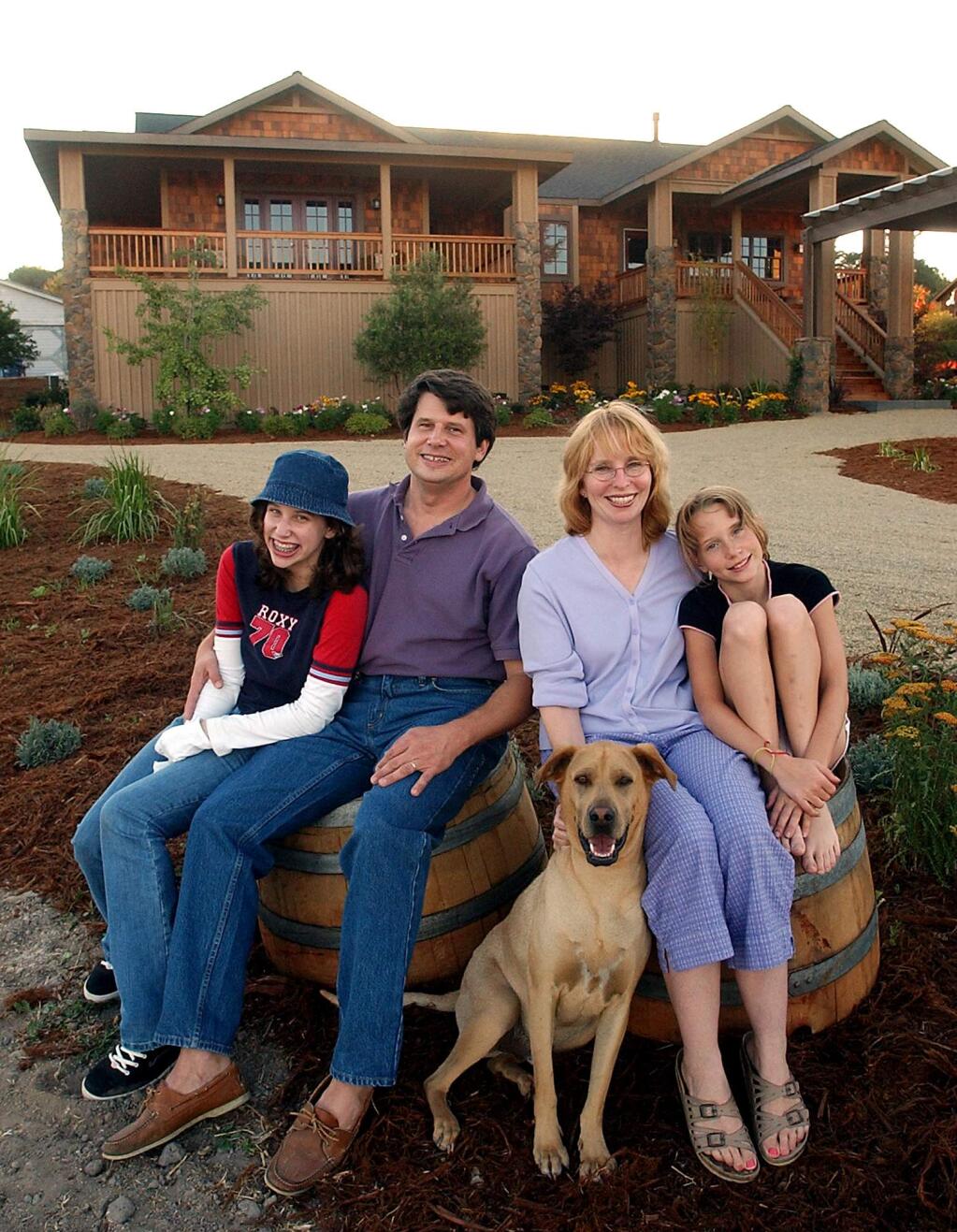 8/13/2004 FILE PHOTO: Matthew and Caroline Pope with their kids Shelby, 13, left, and Madison, 10, and the family dog, George, a 3-year-old Lab , Shar-Pei mix, in front of their '' Extreme Makeover'' house in Penngrove.