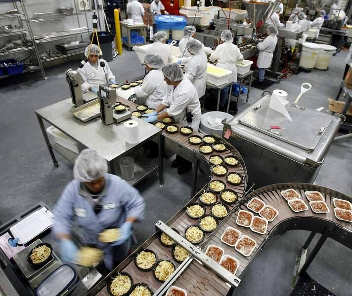 Employees at Amy's Kitchen assemble frozen foods by hand at the northwest Santa Rosa plant on Sept. 25, 2007. The facility at 2330 Northpoint Parkway was one of three company-owned production facilities that changed hands in December 2021 in a sale-leaseback deal. (Press Democrat / Jeff Kan Lee)