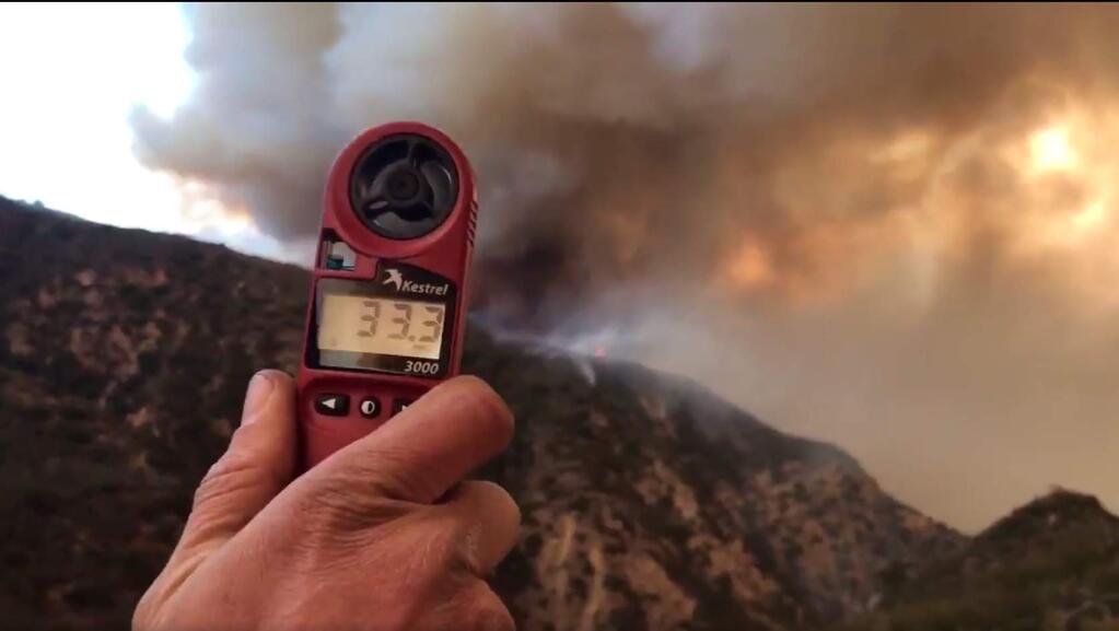 In this image from video provided by the Santa Barbara County Fire Department, a wind speed indicator held by a U.S. Forest Service fire fighter on Gibraltar Road at the W. Fork of Cold Spring Trail, shows just how fast and varied the speed of the wind is blowing down canyon. In this video it varied from 10-33 mph in Santa Barbara, Calif., Saturday, Dec. 16, 2017. Wind gusts of up to 52 mph have been recorded in the area using a hand held weather device. The Office of Emergency Services announced the orders Saturday as Santa Ana winds pushed the fire close to the community. The mandatory evacuation zone is now 17 miles long and up to 5 miles wide, extending from coastal mountains northwest of Los Angeles to the ocean. Winds in the foothill area are hitting around 30 mph, with gusts up to 60 mph. (Mike Eliason/Santa Barbara County Fire Department via AP)