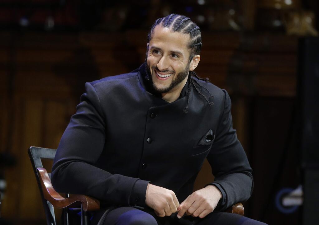 In this Oct. 11, 2018, file photo, former NFL quarterback Colin Kaepernick smikes on stage during the W.E.B. Du Bois Medal ceremonies at Harvard University in Cambridge, Mass. (AP Photo/Steven Senne, File)