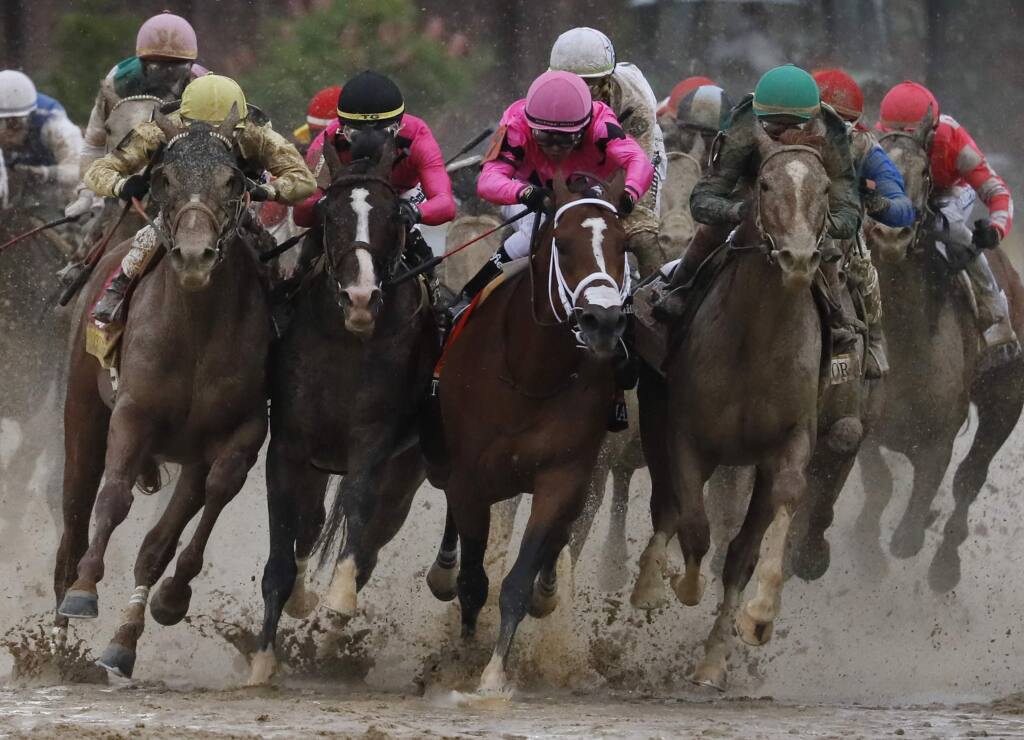 In this May 4, 2019, file photo, front row from left: Flavien Prat on Country House, Tyler Gaffalione on War of Will, Luis Saez on Maximum Security and John Velazquez on Code of Honor compete in the 145th running of the Kentucky Derby horse race at Churchill Downs in Louisville, Ky. (AP Photo/John Minchillo, File)