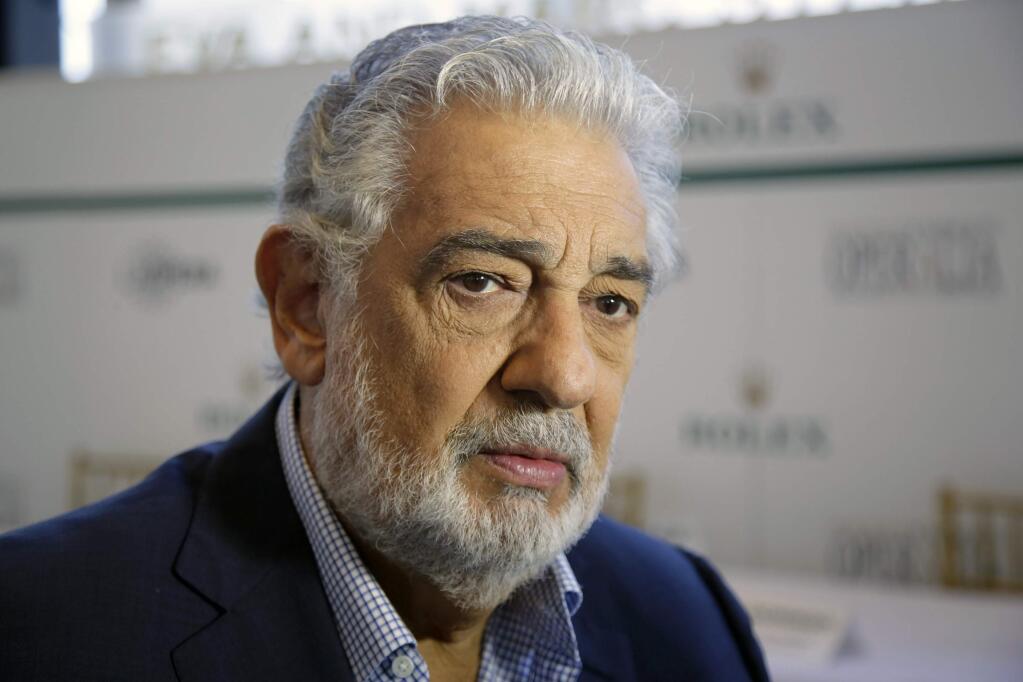 FILE - In this Aug. 26, 2014, file photo, Spanish tenor Placido Domingo gives details about the opera competition Operalia at the Dorothy Chandler Pavilion in Los Angeles. Opera star Placido Domingo has resigned as general director of the Los Angeles Opera following multiple allegations of sexual harassment reported by The Associated Press. In a statement Wednesday, Oct. 2, 2019, Domingo said the allegations have 'created an atmosphere in which my ability to serve this company that I so love has been compromised.' He has served as general director since 2003. (AP Photo/Damian Dovarganes, File)