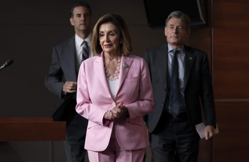 Speaker of the House Nancy Pelosi, D-Calif., joined by Rep. John Sarbanes, D-Md., left, and Rep. Tom Malinowski, D-N.J., leads House Democrats to discuss H.R. 1, The For the People Act, which passed in the House but is being held up in the Senate, at the Capitol in Washington, Friday, Sept. 27, 2019. (AP Photo/J. Scott Applewhite)