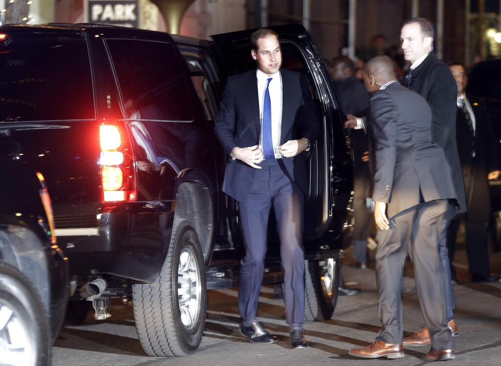 Prince William, center, arrives at his hotel in New York, Sunday, Dec. 7, 2014. (AP Photo/Seth Wenig)