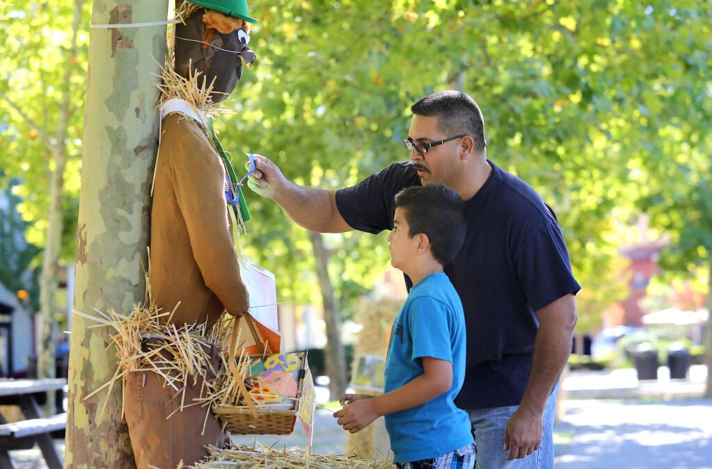 PHOTO: 1 Press Democrat file PHOTO , 2012-Fabian Palacios and his son Marco check out Marco's scarecrow contest entry at the Windsor Town Green in 2012.