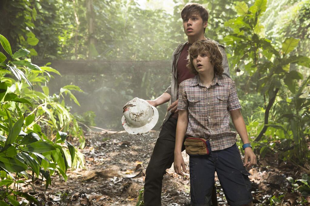 This photo provided by Universal Pictures shows, Nick Robinson, left, and Ty Simpkins in a scene from the film, 'Jurassic World,' directed by Colin Trevorrow, in the next installment of Steven Spielberg's groundbreaking 'Jurassic Park' series. The 3D movie releases in theaters by Universal Pictures on June 12, 2015. (Chuck Zlotnick/Universal Pictures via AP)